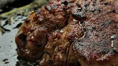 Panorama of a piece of meat that is fried in a pan Stock Footage 237331387