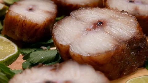 Panorama of pieces of smoked eel lying on a wooden board Stock Footage 274873874