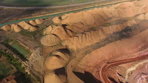 Panorama of the quarry. Artificial lake. Sunset. Barkhan sands. Development of 動画素材 75250027