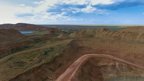 Panorama of the quarry. Artificial lake. Sunset. Barkhan sands. Development of Vídeo Stock 75289394