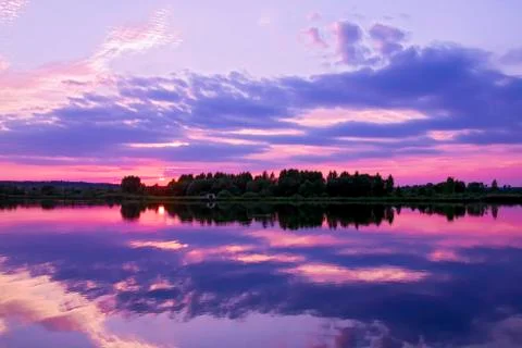 Panorama of the reflection of the sunset in the lake. Stock Photos