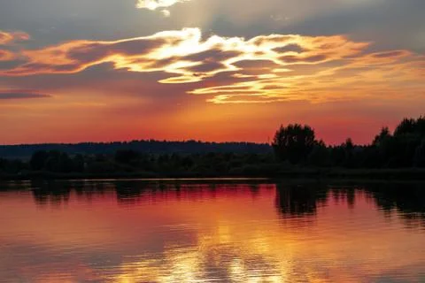 Panorama of the reflection of the sunset in the lake. Stock Photos
