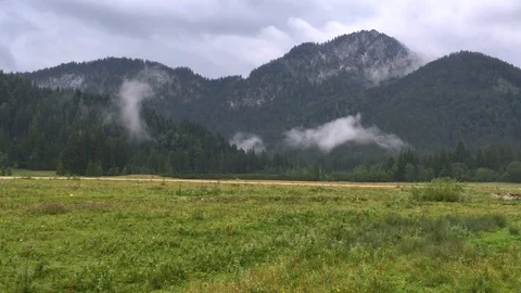 Panorama of remote mountain valley, single alp farm buildings Stock Footage 122115809