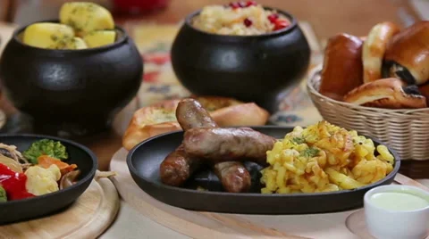 Panorama of rich country table layout with dishes of restaurant home cuisine Stock Footage 68094322