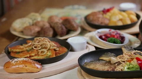 Panorama of rich set table layout with dishes of restaurant home cuisine Stock Footage 58408742