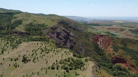 Panorama of rugged basalt mountainside and eroded red canyon rift in Kazakhstan Stock Footage 337680527