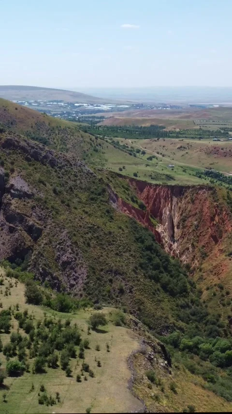 Panorama of rugged basalt mountainside and eroded red canyon rift in Kazakhstan Stock Footage 338127754