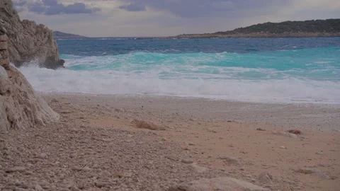 Panorama of a sandy beach with rocks. Yellow sand and clear sea.  Stock Footage 169667752