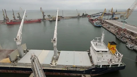 Panorama of ship loading grain crops on bulk freighter via trunk to open cargo Video stock 90433677