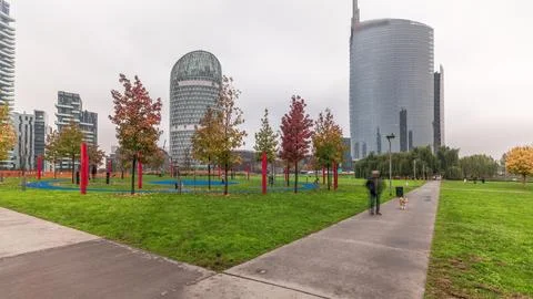 Panorama showing skyscrapers and biblioteca from park with green lawn and ora Stock Photos