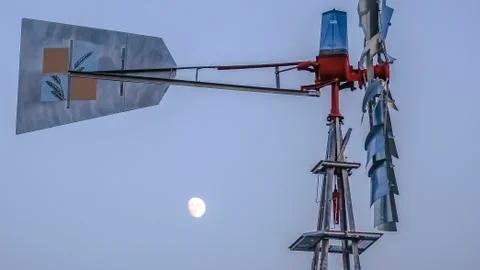 Panorama Side view of a windpump with moon and sky in the background Stock Photos