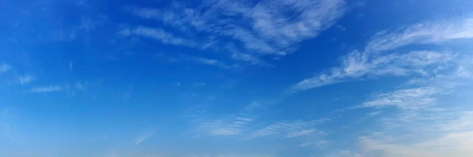 Panorama sky with cloud on a sunny day. Beautiful cirrus cloud. Stock Photos