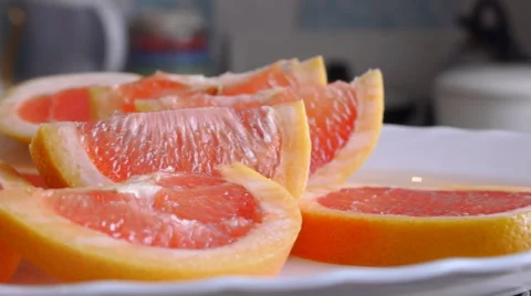 Panorama Of Sliced  Grapefruit On The Plate Stock Footage 64881612