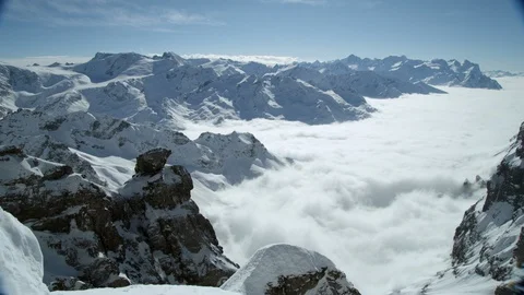 Panorama of snow capped Alpine peaks in bright midday sun light, Swiss Alps Stock Footage 129090372