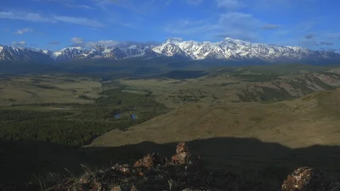 Panorama of the snowy peaks of the mountain range. Green meadow. 4K Stock Footage 123544731