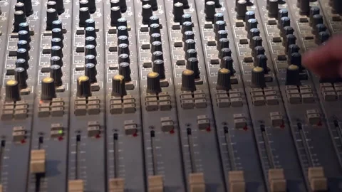 Panorama by soundboard. Man's hand moves sliders and pushes buttons on console Stock Footage