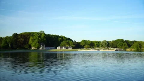 Panorama of spring lake view, green woods and houses by the lake Stock Footage 145676016