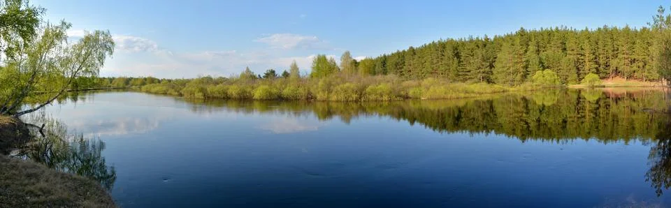 Panorama of the spring river. Stock Photos