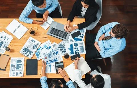 Panorama top view diverse analyst team analyzing financial data. Meticulous Stock Photos