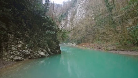 Panorama of turquoise calm river in forest and rock 스톡 동영상 84772147