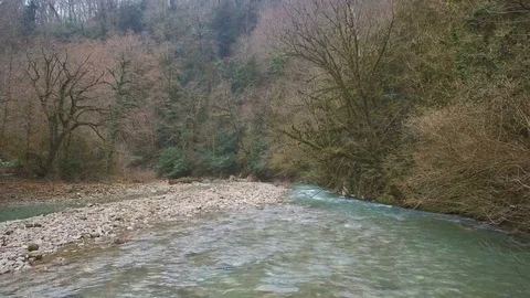 Panorama of turquoise calm river in forest and rocky shore 스톡 동영상 84772436