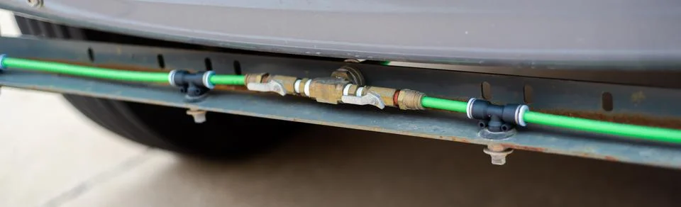 Panorama view flow control valves fill hose with spray nozzles front of str.. Stock Photos