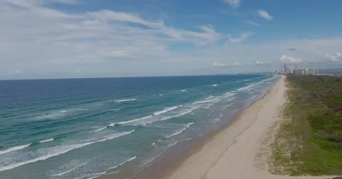Panorama view of long stretch of Australian sandy beach and little boat Stock Footage 64740030