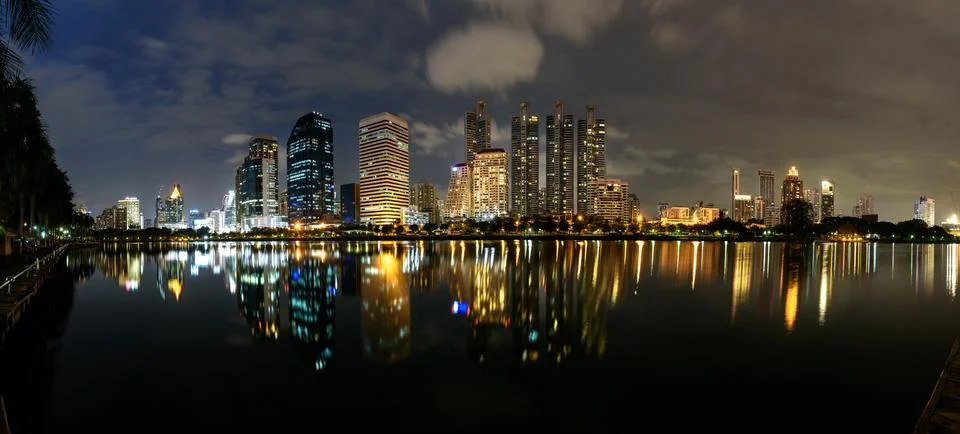 Panorama View, Modern buildings of Benchakitti Park with lights reflection Stock Photos