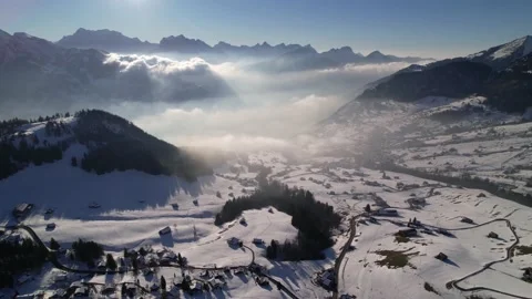 Panorama view over romantic winter mountain ski resort, aerial dolly left Stock Footage 169547704
