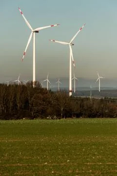 A panorama view over wind farm landscape in Germany with white generator turb Stock Photos