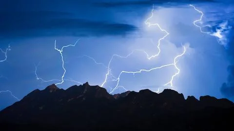 Panorama view of thunder storm lightning strike over mountain with dark cloud Foto stock