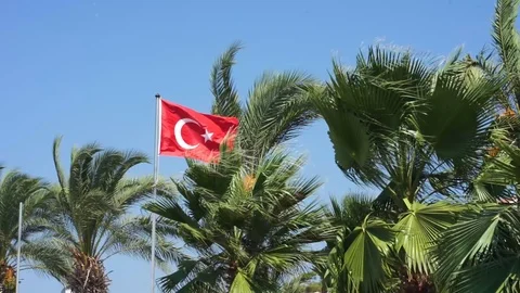 Panorama view of the Turkish flag waving wind against a blue sky surrounded by Stock Footage 126336674