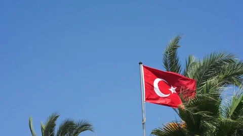Panorama view of the Turkish flag waving wind against a blue sky surrounded by Stock Footage 126337225