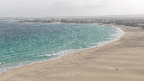 Panorama view of two people walking on sandy beach in Cape Verde Stock Footage 325446444