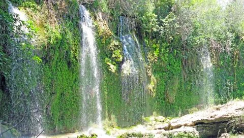 Panorama of waterfall cascade in deep forest Stock Photos