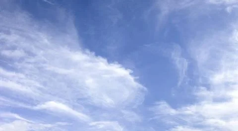 Panorama of white soft blurred clouds on a background of blue sky. Panoram... Stock Photos