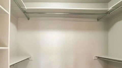 Panorama Windowless empty walk-in closet with vertical framed shelves on the 스톡 사진