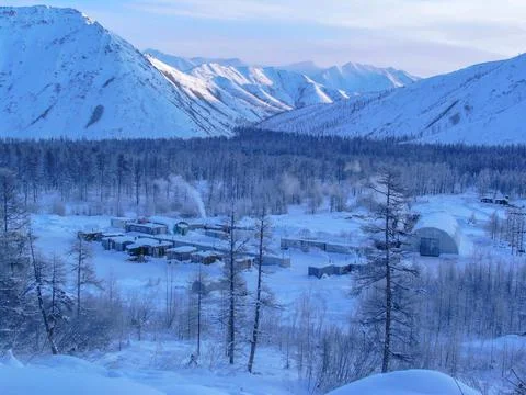 Panorama of winter view of worker's camp in taiga on snowy morning or evening 库存照片