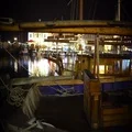 Panorama of wooden fishing boat parked in harbor, beautiful evening cityscape 4k or 4k+ Resolution
