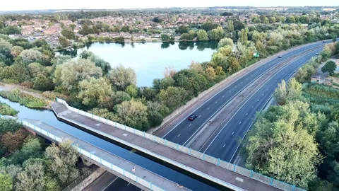 Panoramic Aerial Drone Orbit Around Cars, Road, Bridge and Nature Lake Stock Footage 341628243