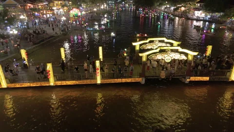 Panoramic aerial drone view of Hoi An Ancient town with boat tour in evening Video stock 289260680