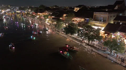 Panoramic aerial drone view of Hoi An Ancient town with boat tour in evening Video stock 289260824