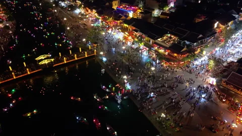 Panoramic aerial drone view of Hoi An Ancient town with boat tour in evening Video stock 308955940