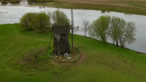 Panoramic aerial drone view of old vintage wooden windmill in spring summer time Stock Footage 154206046
