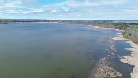 Panoramic Aerial Drone View of a Vast Lake and Sandy Shoreline in Spring Stock Footage 312417936