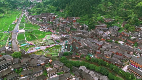 Panoramic Aerial Drone View of Xijiang Qianhu Miao Village and Rice Plantation Stock Footage 341741702