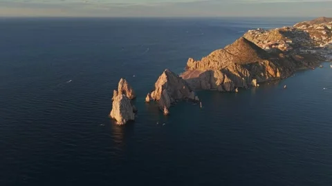 Panoramic aerial orbit of the rock formations in Cabo San Lucas Bay at sunset Stock Footage 334833671