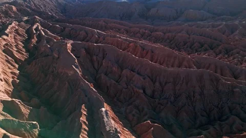 Panoramic aerial over vast deeply eroded salt rock badlands with dramatic sharp Stockbeeldmateriaal 336266134