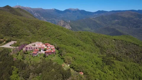 Panoramic aerial shot of isolated castle town on mountain hillside Stock Footage 337048711