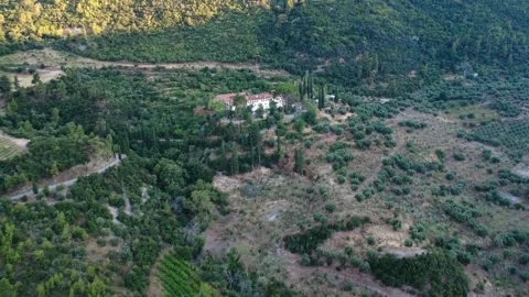 Panoramic aerial shot of an old Byzantine monastery on a green slope Stock Footage 343962097